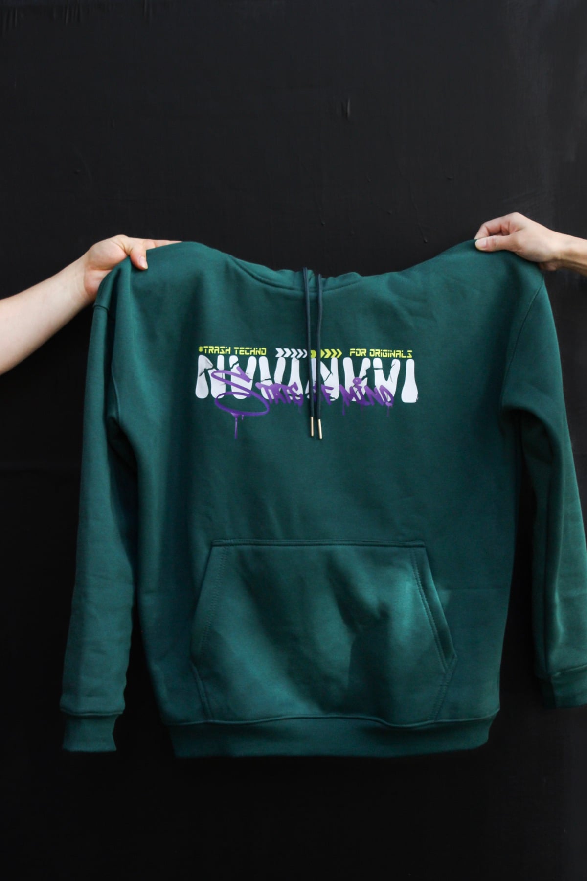 VINV forest-green hoodie laid flat on black, white and purple NVVINVVI print on the back