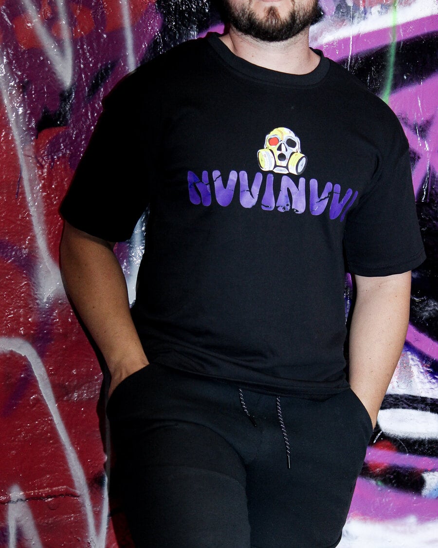 VINV black t-shirt with purple print, worn against a magenta graffiti wall